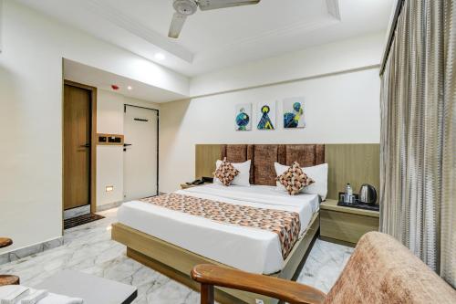 a bedroom with a large bed in a room at Hotel Royal Stay, Pakwan Sg Highway in Ahmedabad