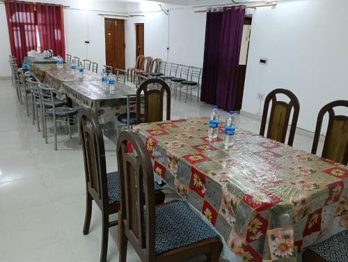 a group of tables with bottles of water on them at Monal Inn in Mīlam