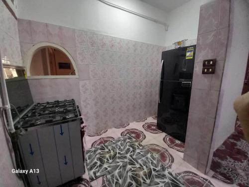 a kitchen with a stove and a counter top at شقة سكنية in Shibīn al Kawm