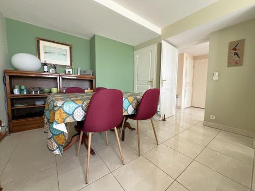 une salle à manger avec une table et des chaises violettes dans l'établissement Appartement avec vue bassin, accès plage, parking inclus - FR-1-474-278, à Arcachon