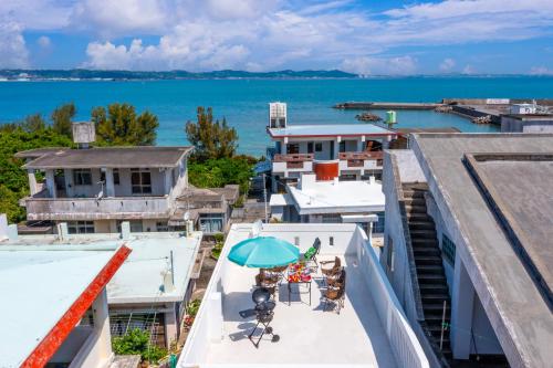 an overhead view of a balcony with an umbrella and chairs at 海野Sea Terrace in Nanjo
