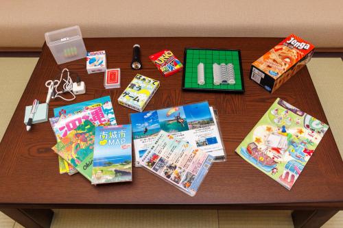 a table with books and other items on it at 海野Sea Terrace in Nanjo