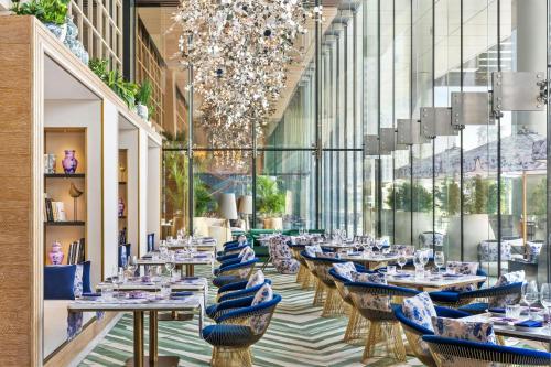 a restaurant with tables and chairs in a building at The St. Regis Downtown Dubai in Dubai