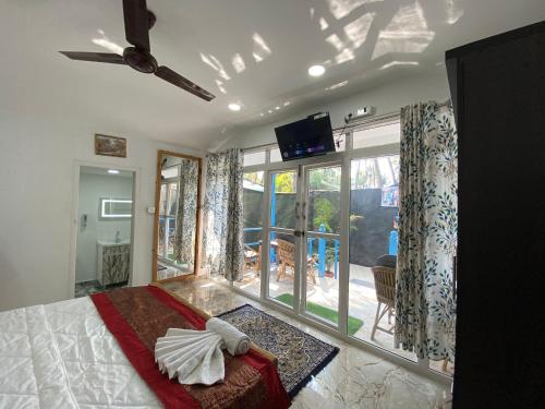 a bedroom with a bed and a large window at Mystic Nest in Canacona