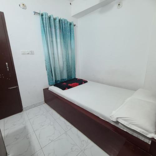 a small room with a bed and a window at Hotel Muna International Residential 6th floor in Dhaka