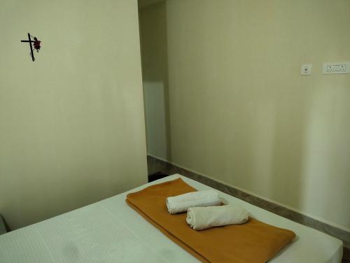 a room with a bed with two towels on it at Bal Ganesha beach resort in Canacona