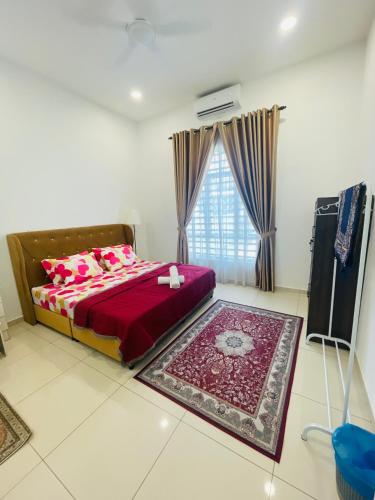 a bedroom with a bed with red sheets and a window at Rafflesia Homestay- For Malay Only in Solok Belimbing