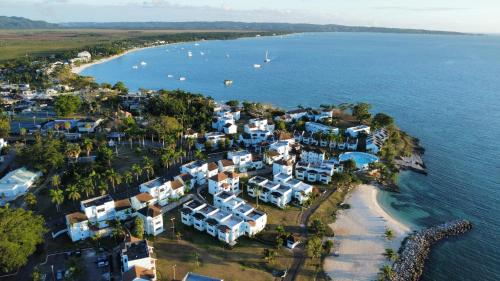 an aerial view of a small island with blue and white houses at Negril beachfront oceanview studios 164 & 145 in Orange Bay