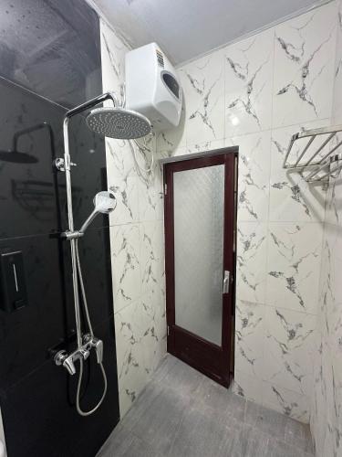 a bathroom with a shower and a mirror in it at Melayu Asri Hotel in Negara
