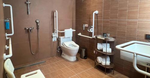 a bathroom with a toilet and a sink and a shower at 采寓halo house in Taichung