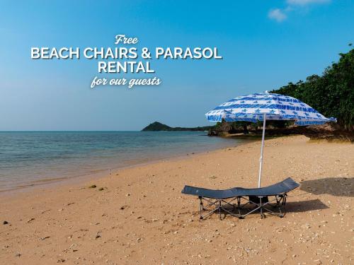 a beach chair and an umbrella on a beach at Sky Ocean - Ishigaki Eco-Resort - Newly Renovated in Ishigaki Island