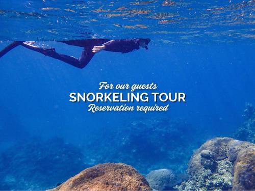 a person swimming in the ocean with the words for our quick snokeling tour at Sky Ocean - Ishigaki Eco-Resort - Newly Renovated in Ishigaki Island