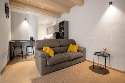 a living room with a couch and a table at MAZZINI 66 appartamenti in Lugo