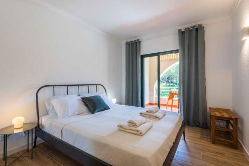 a bedroom with a bed with towels on it at Salgados 1 Bedroom Apartment - 500m from the Beach in Guia
