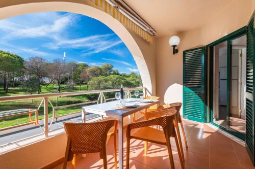 a dining room with a table and chairs on a balcony at Salgados 1 Bedroom Apartment - 500m from the Beach in Guia