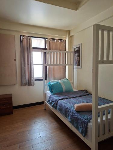 a bedroom with a bunk bed and a window at 59Indy Guesthouse in Bangkok