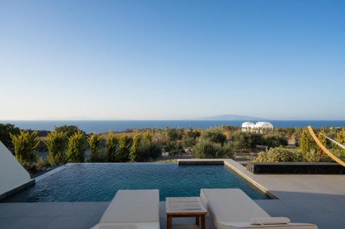 a swimming pool with a view of the ocean at Saint John Oia-Villa With Private Heated Pool in Oia