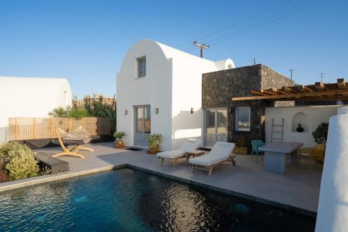 a villa with a swimming pool and a house at Saint John Oia-Villa With Private Heated Pool in Oia