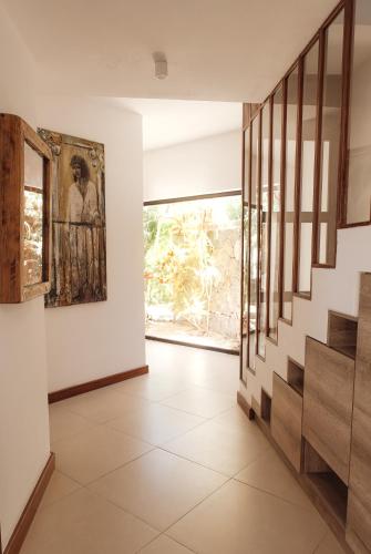 a hallway with stairs and a painting on the wall at Casa del Dodo Villa de luxe avec piscine in Rivière Noire