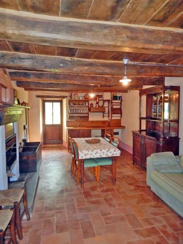 a living room with a table and a kitchen at Pieve di Cà Maggiore in Firenzuola
