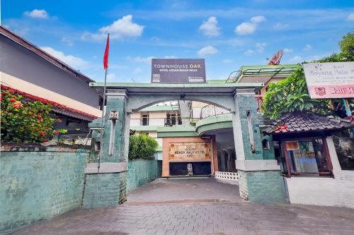 an entrance to a building with an archway at Townhouse Oak Legian Near Kuta Beach Formerly Sayang Maha Merta in Legian