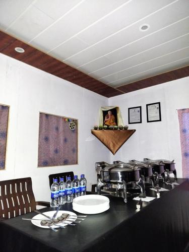 a kitchen with a counter with bottles of water at Ibex spangri cottage in Lukung