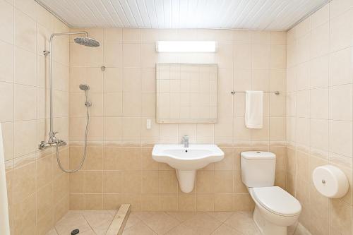 a bathroom with a sink and a toilet and a shower at Lotus Family Hotel - Free Parking in Sunny Beach