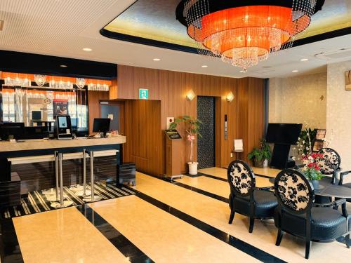 a lobby with chairs and a bar in a hotel at APA Hotel Tokushima Ekimae in Tokushima