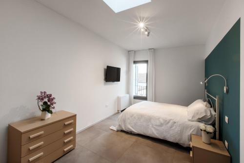 a bedroom with a bed and a dresser and a window at MAZZINI 66 appartamenti in Lugo