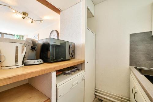 - une cuisine avec un comptoir et une cafetière dans l'établissement Résidence La Mongie 1800 - maeva Home - Studio 4 personnes - Prestige MAE-9951, à La Mongie