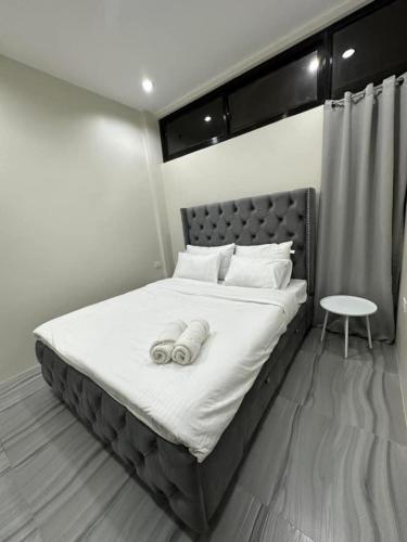 a bedroom with a bed with two towels on it at Kristinas Aparthotel Kabankalan in Kabankalan