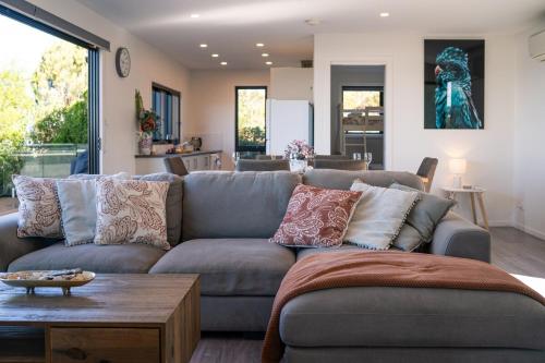 a living room with a couch and a table at Bordaga Unit 2 - Scamander in Scamander