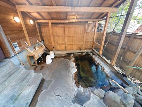 an inside view of a pond in a barn at Kurasako Onsen Sakura in Minamioguni