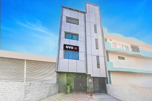 an apartment building with an oo sign on it at Hotel Kalpana in Patna