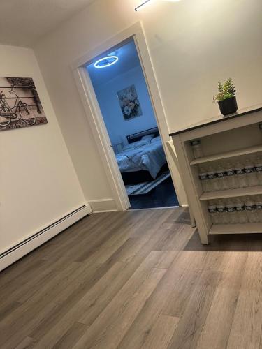 a hallway with a room with a bed and a mirror at Family-friendly for travelers in Warwick