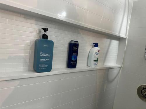 two bottles ofodorizers sit on a shelf in a bathroom at Family-friendly for travelers in Warwick