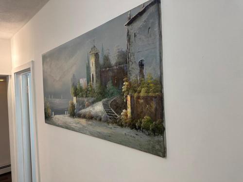 a painting hanging on a wall on a wall at Family-friendly for travelers in Warwick