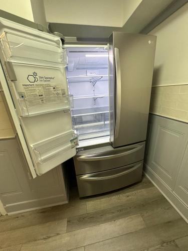 an empty refrigerator with its door open in a kitchen at Family-friendly for travelers in Warwick