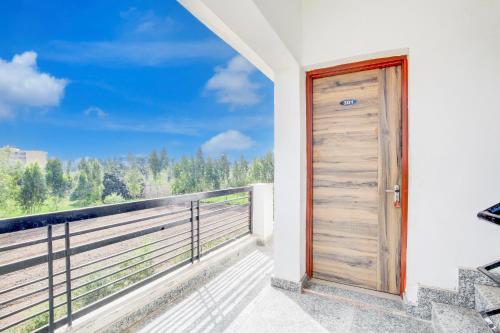 a door on a balcony with a view at Hotel O KLER Guest House in Kharar