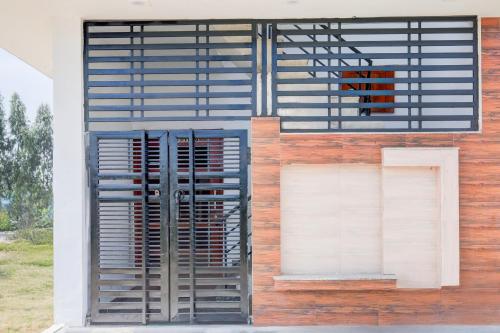 a building with a gate on the side of it at Hotel O KLER Guest House in Kharar