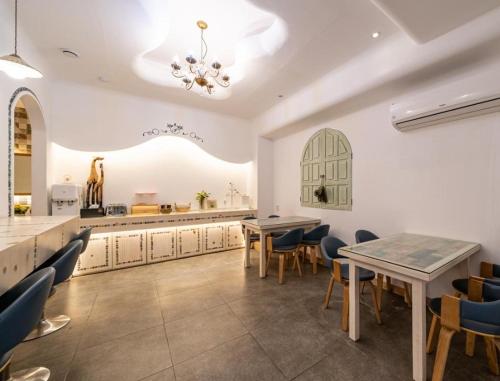 a dining room with two tables and chairs at Asan Paradise in Asan