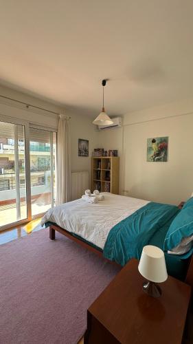 a bedroom with a large bed and a table at Modern Flat in Nafplio in Nafplio