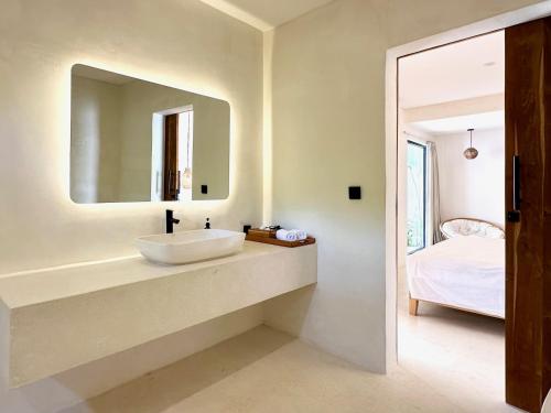 a bathroom with a sink and a mirror at The Ulu Hills in Uluwatu