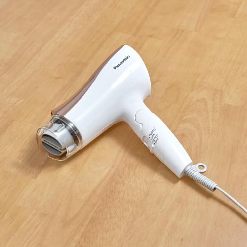 a white electric hair dryer sitting on a wooden table at Y's INN Oyama 021T in Tokyo