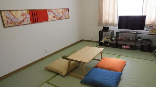 a living room with a table and a tv at Y's INN Oyama 021T in Tokyo