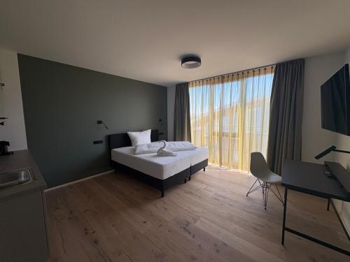 a bedroom with a bed and a large window at New Age Boardinghaus Bad Rappenau in Bad Rappenau