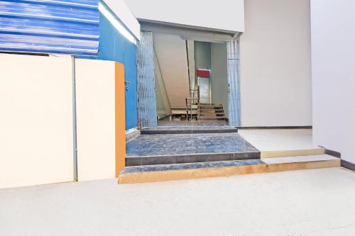a building with stairs leading to a door with a table at Super Collection O Raja Bazar Bailey Road in Patna