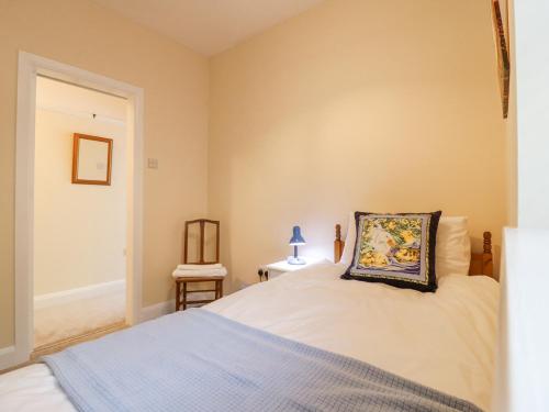 a bedroom with a bed with a pillow on it at Little Danns in Hailsham