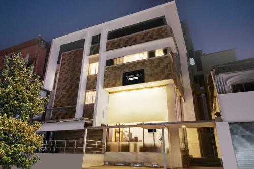 a building with a sign on the side of it at Super Townhouse City Center Near Mysore Palace Formerly Aavass Inn in Mysore