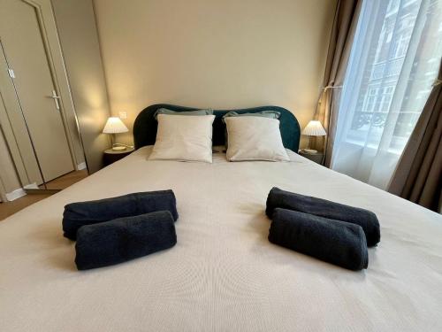 a bedroom with a bed with two pillows on it at Premium Studio 300 m Grand-Place - hyper center Lille in Lille